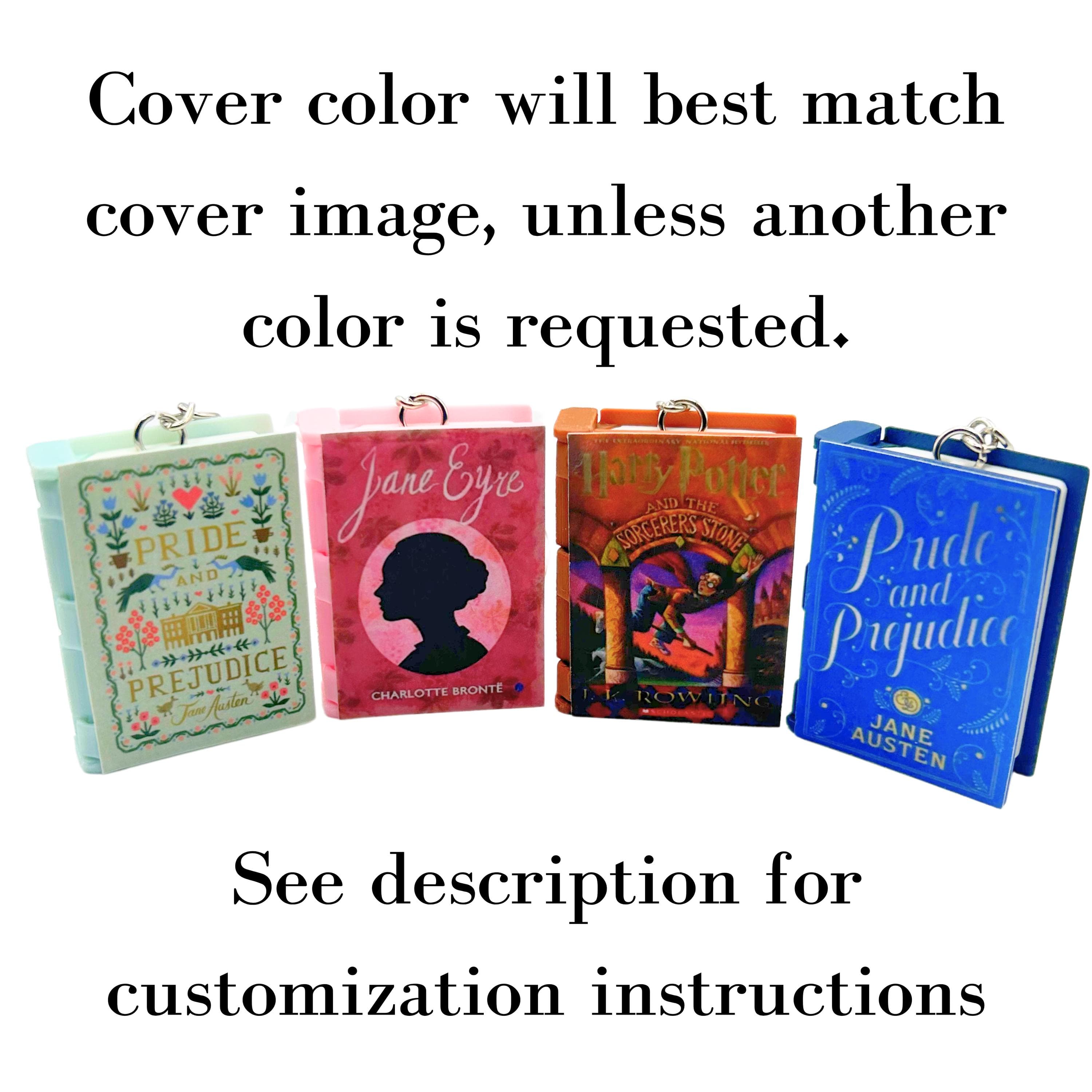 Four mini book keychains with different classic novel covers